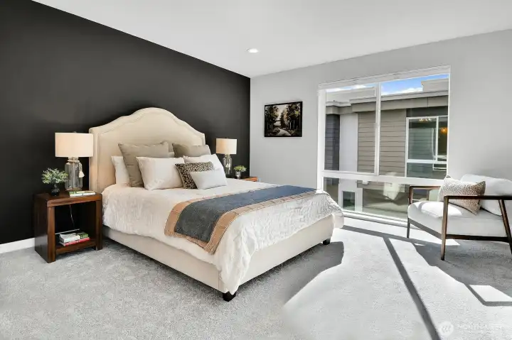 The Primary bedroom has a floor-to-ceiling window that floods the room with light, as well as a walk-in closet and its own 3/4 bath.