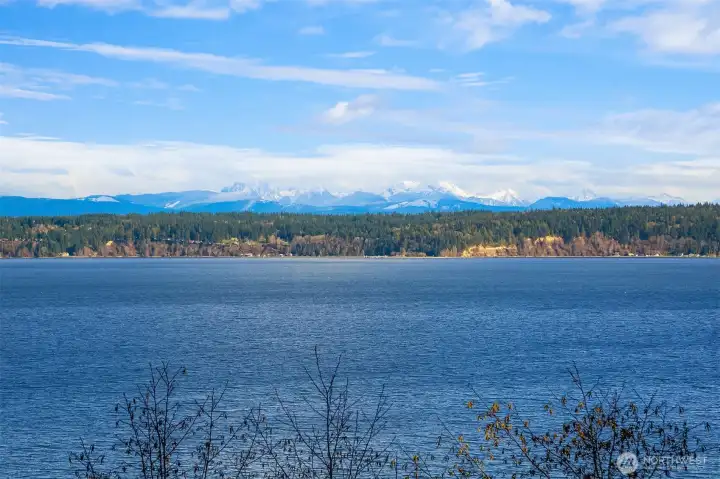 Morning sunrises over Port Susan with Cascade mountain backdrop.