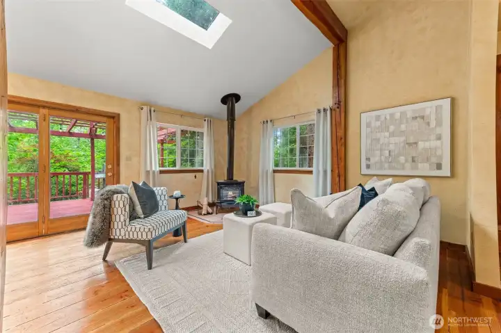 living room and gas heater, leading to back deck