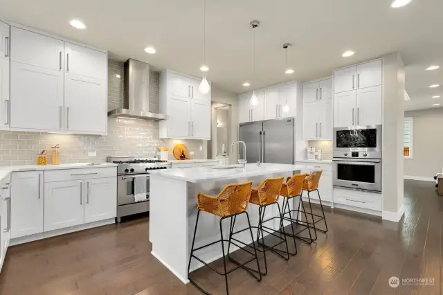 Chef's kitchen features high-end appliances, great workspace + ample storage.