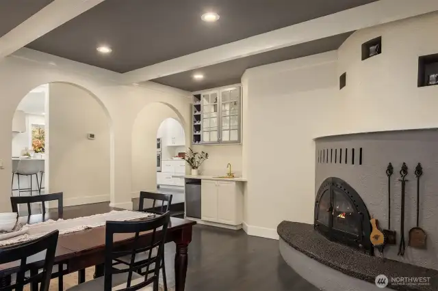 Angle from the dining towards the coffee/bar station and to the kitchen in the background. Arched doorways and curved fireplace provide a warm fuzzy feeling.