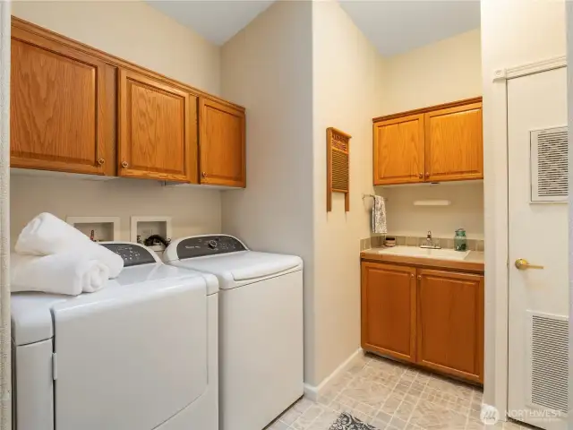 Laundry Room with washer/dryer, utility sink and plenty of storage space.