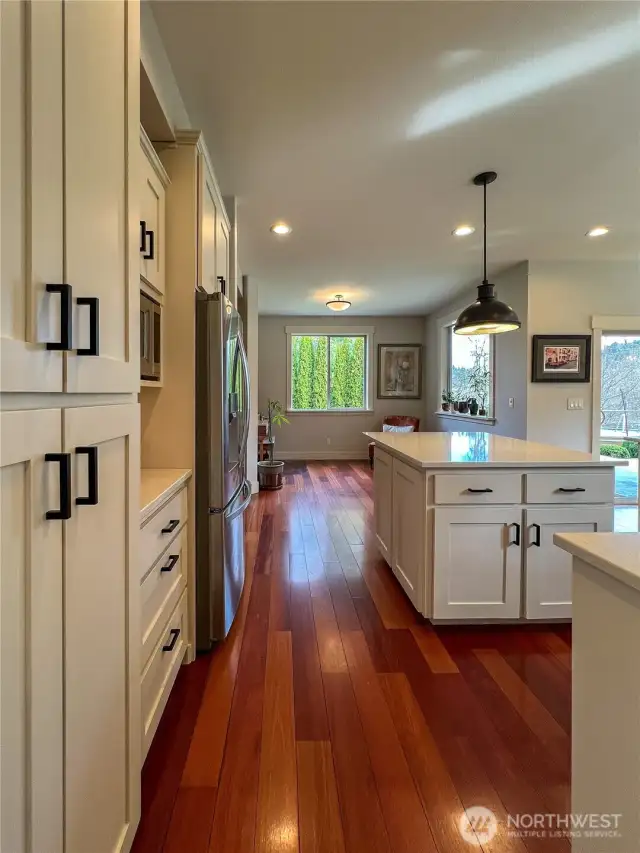 Large Island with quartz counters and bar for additional seating.