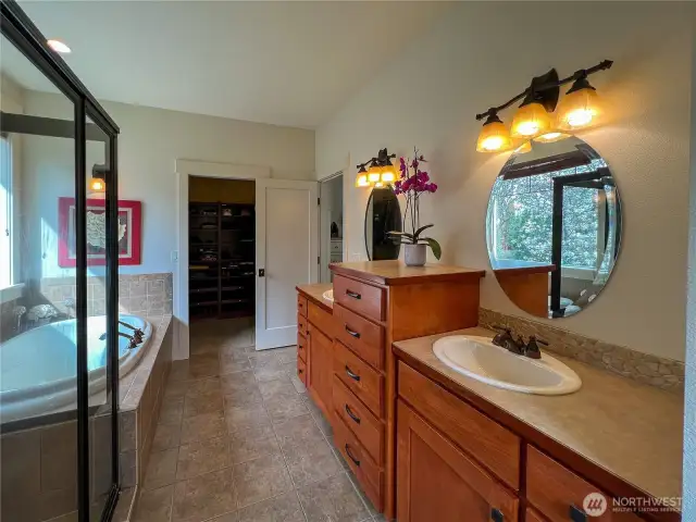 Custom built-in cabinetry and double sinks complete the primary bathroom.