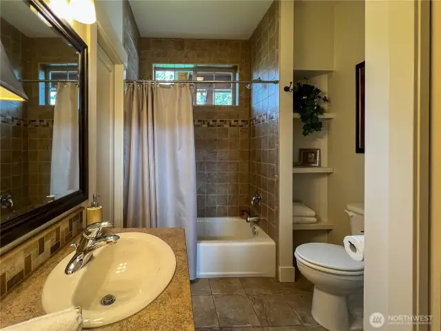 Main floor bathroom with pocket door to bedroom/office.