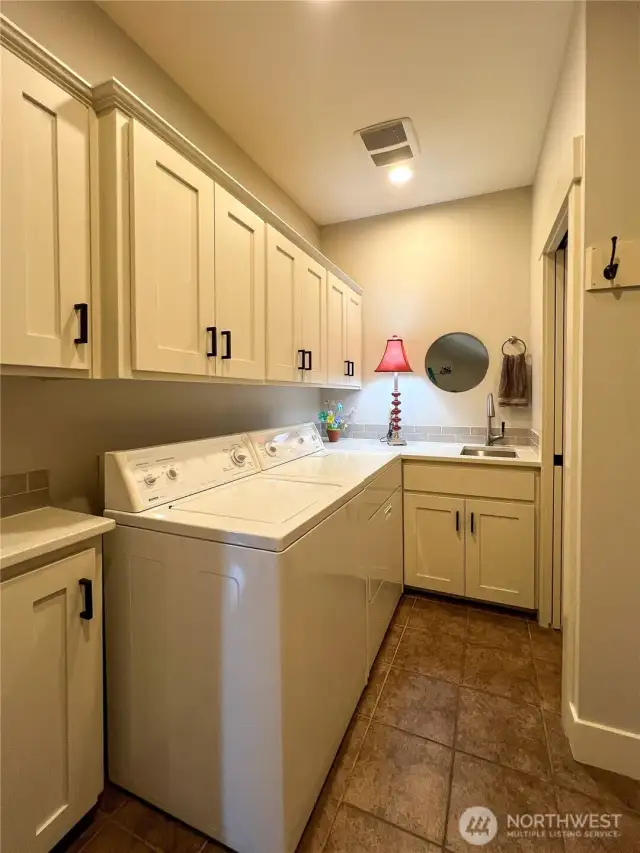 Oversized Laundry, complete with ample storage and utility sink.