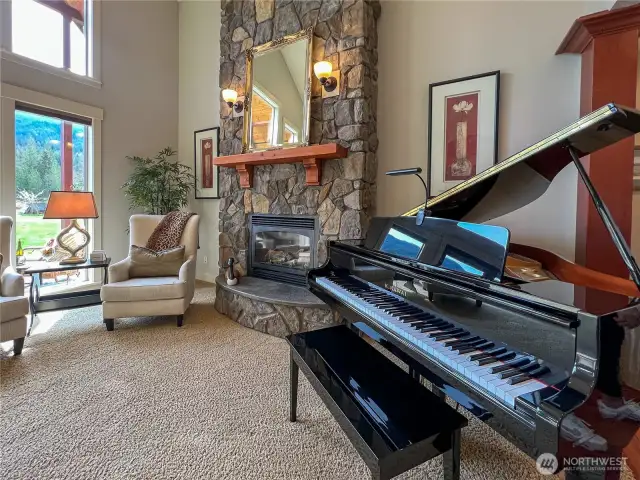 Custom stone fireplace stretches up both stories.