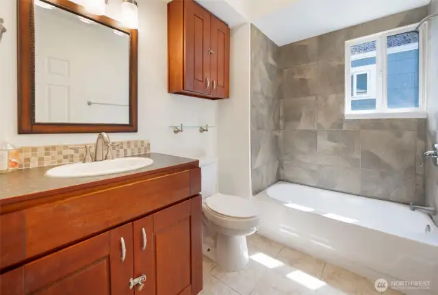 Tub to ceiling tile updated lighting and new paint.