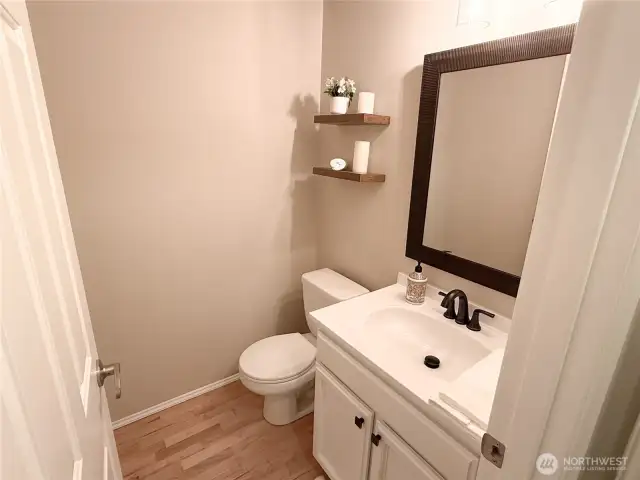 Half bath downstairs recently updated with a new sink, mirror, and faucet.