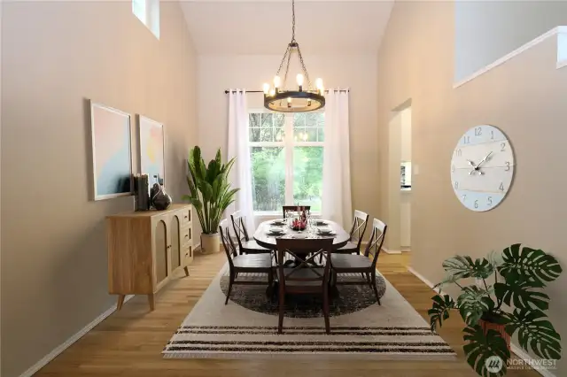 Dining room with a large window and modern light fixture.