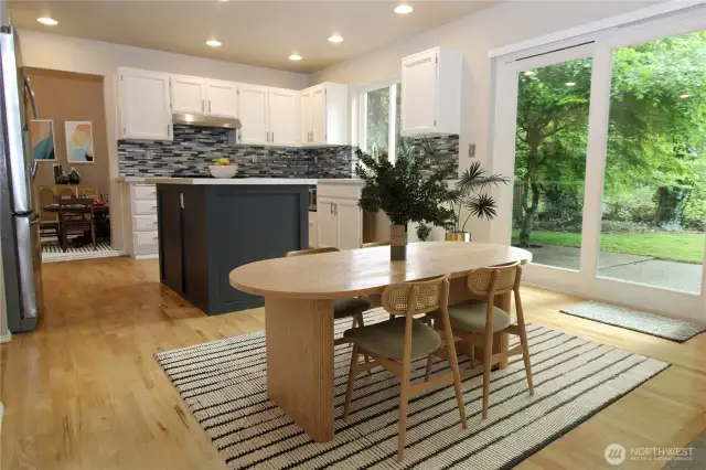 Enjoy the view of your lush yard through the kitchen and slider windows.