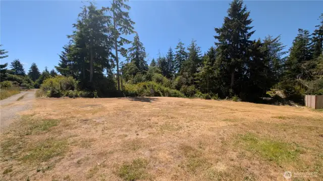 Set among the evergreens, this versatile lot in Sunset Sands is perfect for RV living, weekend camping, or planning your future home. With water already connected and RV-ready electrical hookups offering 20, 30, and 50 amp service, it’s ready for immediate use. Enjoy privacy, easy access, and the perks of a quiet HOA community—where possibilities grow beneath the coastal sky.