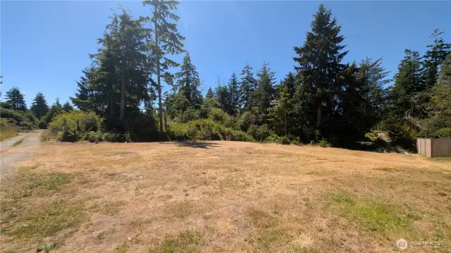 Set among the evergreens, this versatile lot in Sunset Sands is perfect for RV living, weekend camping, or planning your future home. With water already connected and RV-ready electrical hookups offering 20, 30, and 50 amp service, it’s ready for immediate use. Enjoy privacy, easy access, and the perks of a quiet HOA community—where possibilities grow beneath the coastal sky.