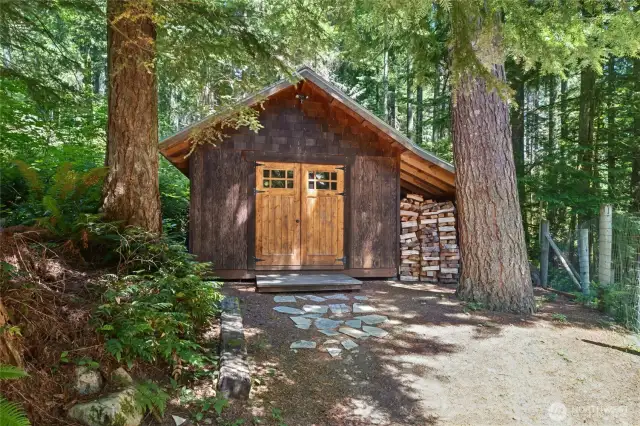 Large storage shed plus covered wood storage.