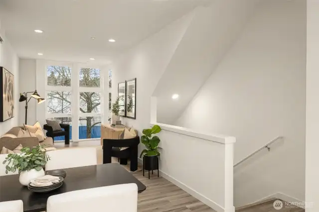 Residential upper floor features window treatments, vinyl flooring, large windows and a minisplit for heating and cooling.
