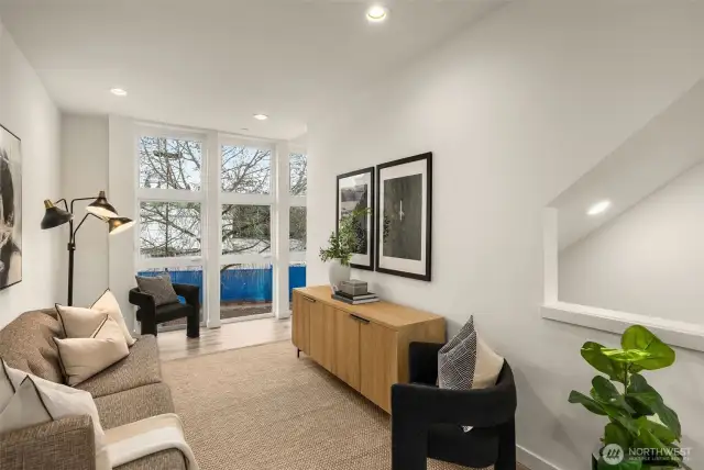 Residential upper floor features window treatments, vinyl flooring, large windows and a minisplit for heating and cooling.
