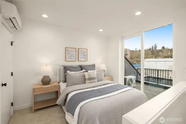Primary bedroom on the third floor features a private deck, minisplit for heating and cooling, and a double sink ensuite with a walk-in shower.