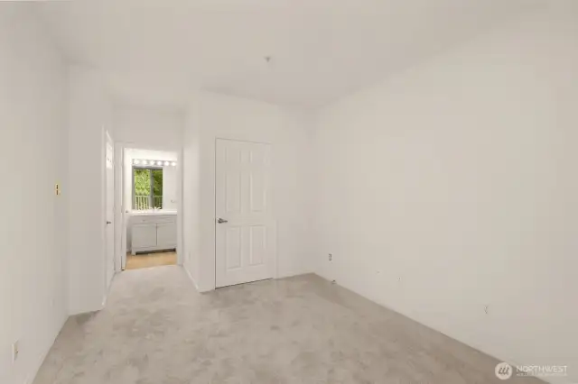 Primary bedroom with walk-in closet and attached bathroom