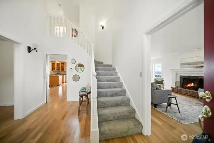 Upon entering please see formal dining/potential main floor bedroom on left, entry to kitchen and living room with wood burning fireplace on right.. Great natural light and beautiful hardwoods.