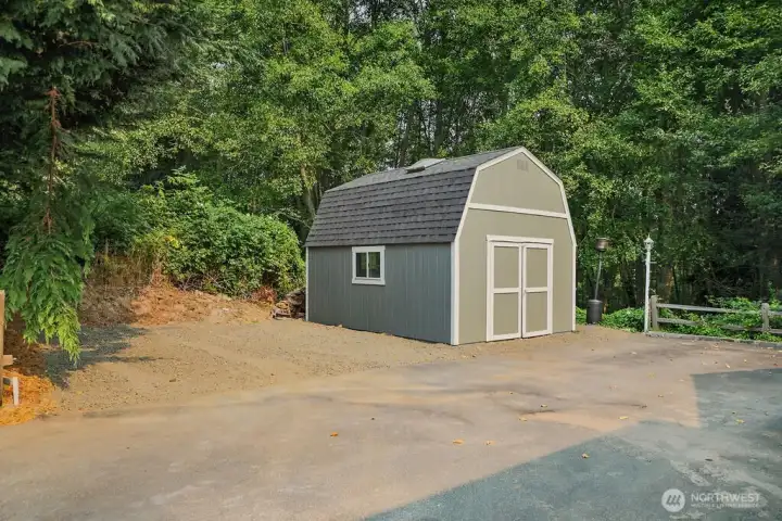 Outbuilding has new roofing and paint.