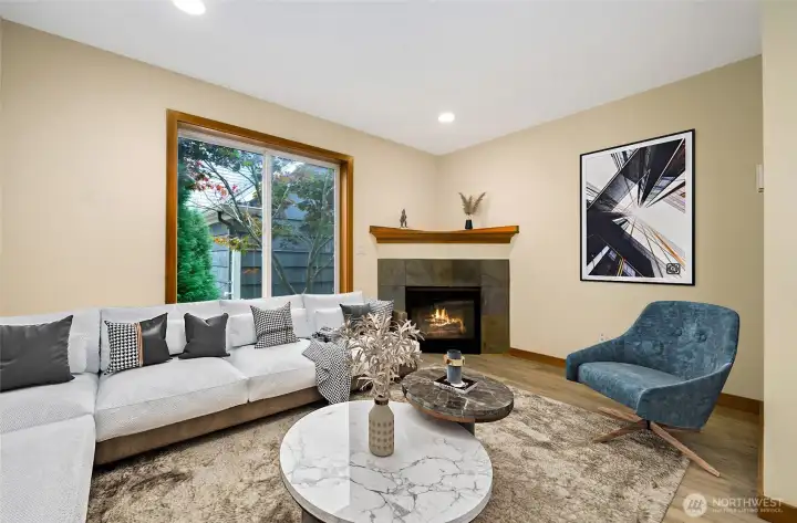 Living with Gas Fireplace and large picture window facing East.