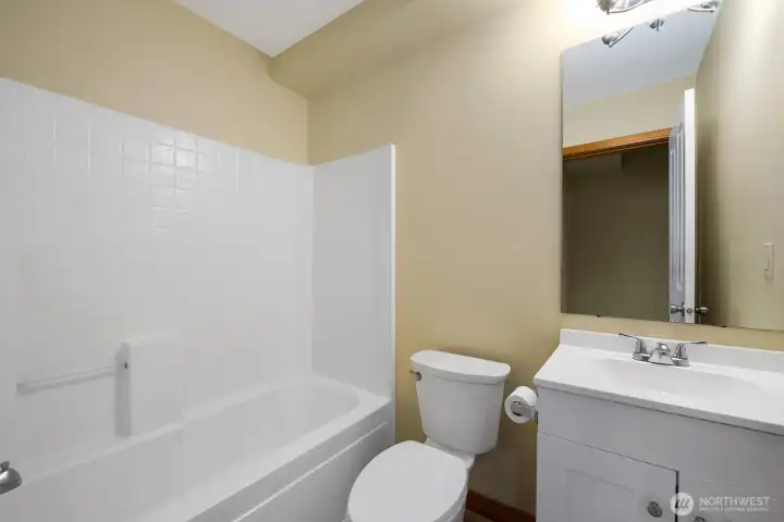 Full Bath on the Entry Level with new Vanity and LVP Flooring.   Next to this Bath is a walk-in Utility Room with brand-new Samsung Washer/Dryer Set.