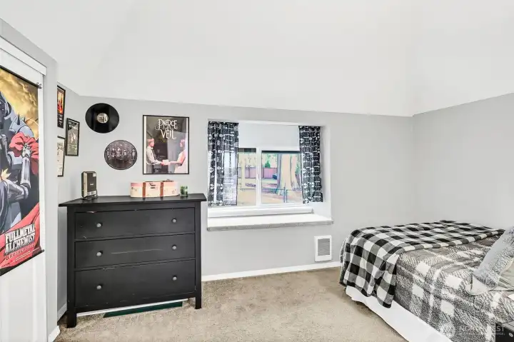 Upstairs leads to 2 of the bedrooms. This secondary bedroom is spacious with a bench window seat with storage