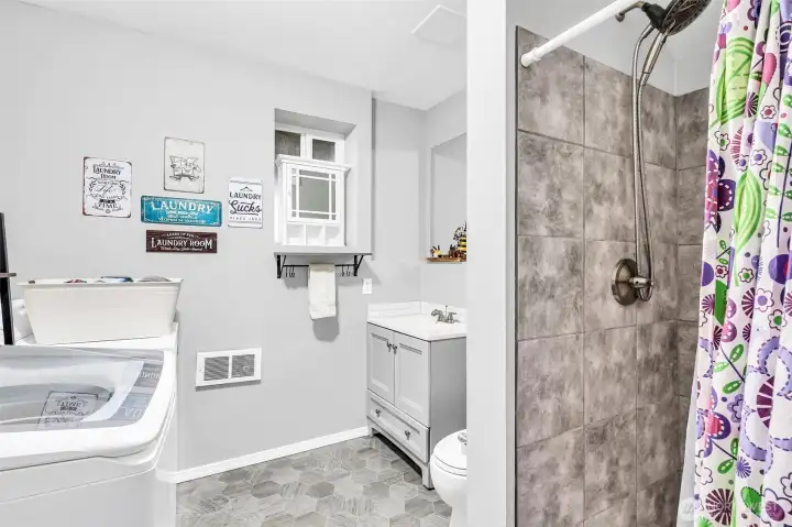 3/4 bath plus laundry room with newer vinyl floors, updated vanity & tile shower. Everything in this home has been done for you. Just move in!