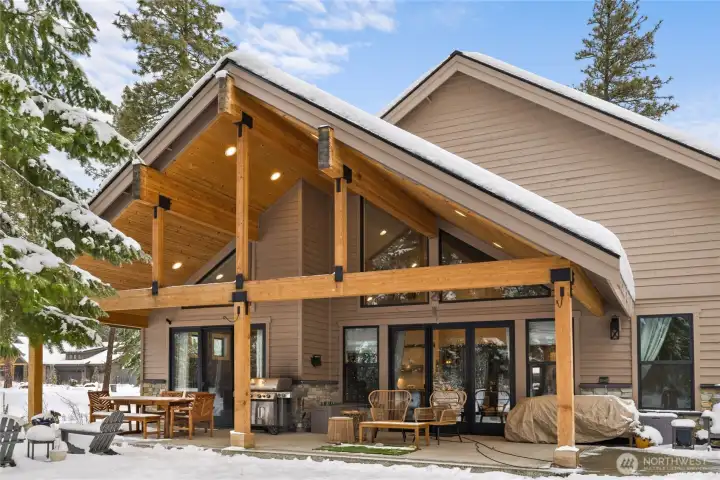 Double sliding glass doors lead out to covered porch on the park