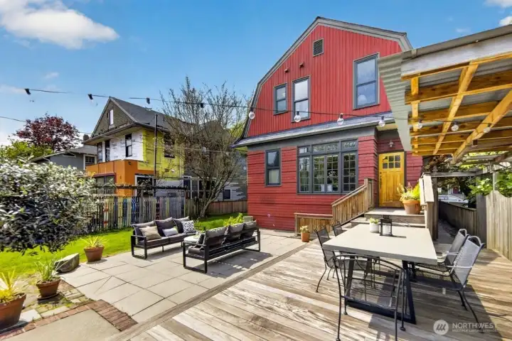 Extending from the kitchen is a elevated Ipe deck and paver patio which stretches onto the expansive yard.