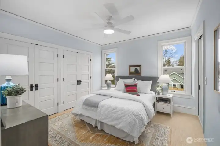 Primary bedroom with a wall of closets