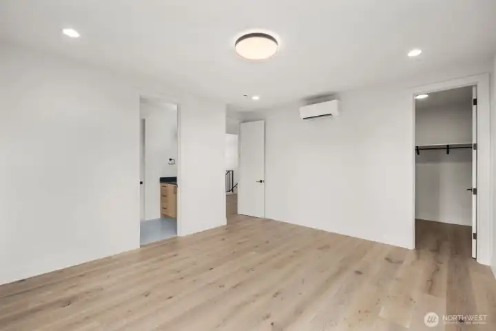 One of the 3 upstairs bedrooms features engineered hardwood floors walk in closet and bath