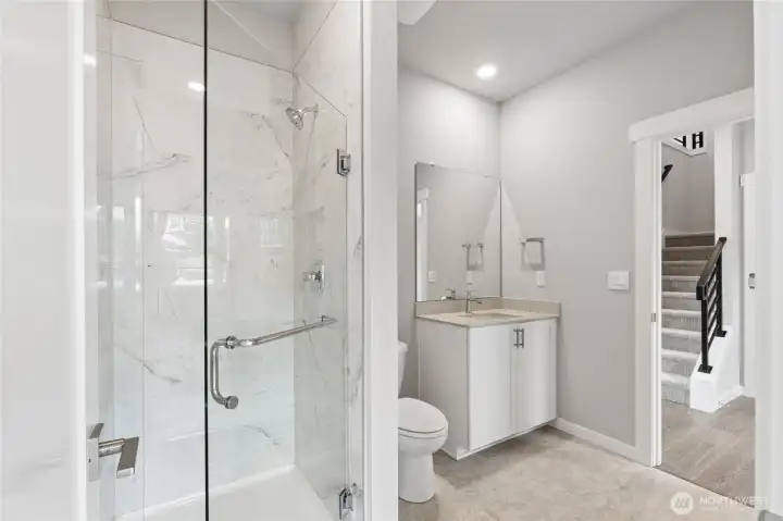 Main floor bathroom has dual access to hallway and bedroom.