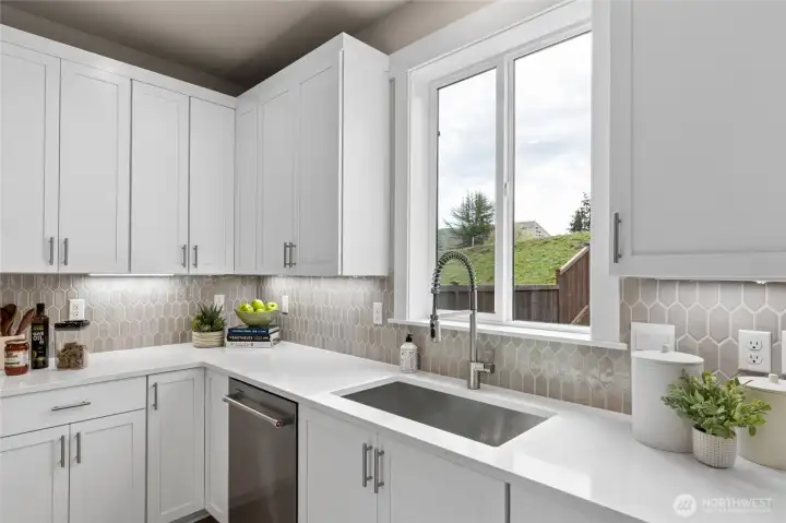 Moen faucets and stainless steel undermount sinks grace the modern kitchens. Timeless white cabinetry in all homes