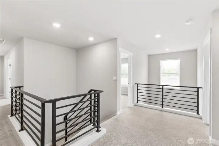 Wide hallways with iron stair railings.
