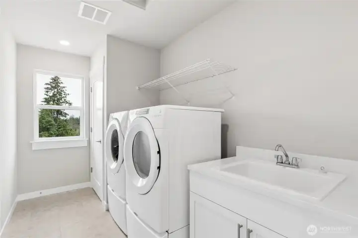 Top floor laundry includes pedestal washer dryer, folding area and sink!