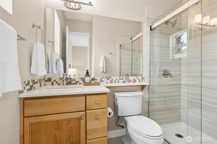 En-suite bathroom with upgraded shower has 3 piece custom surround and glass doors