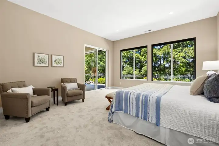 Generous primary suite complete with views of greenbelt and slider to covered patio