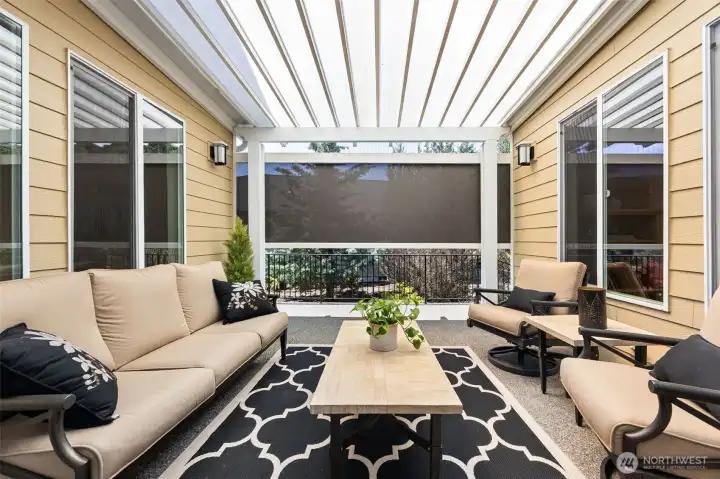 Covered patio off the kitchen has electric screen