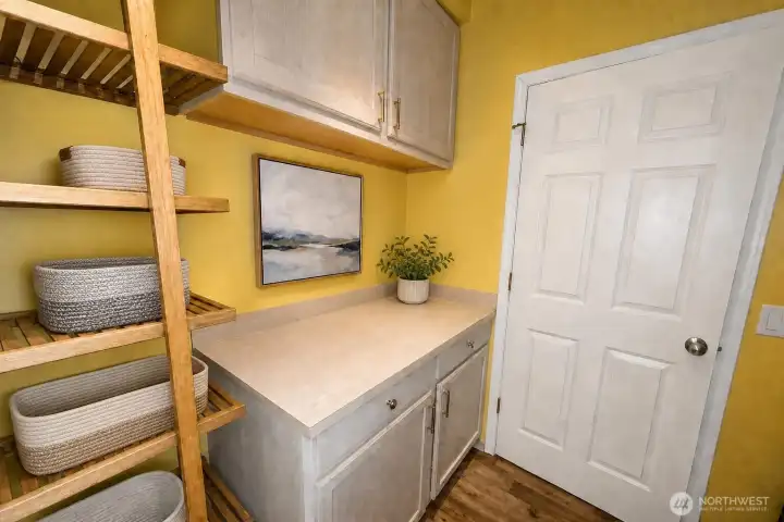 Downstairs laundry room has been virtually staged