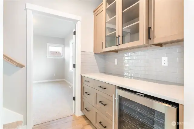 Wine/beverage fridge. Stairway to the left. Primary straight ahead.