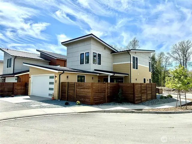 Corner lot with private fenced in and gated backyard.
