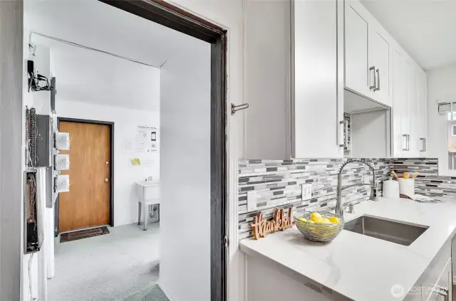 The kitchen also provides access to the shared laundry room and assigned storage unit, though you have your own in-unit laundry upstairs as well.