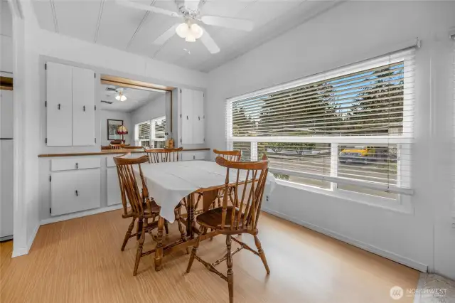 The dining room has a wonderful built-in side bar for plenty of storage and display counter space. A ceiling fan with lighting over the table. Lots of room for a big table.