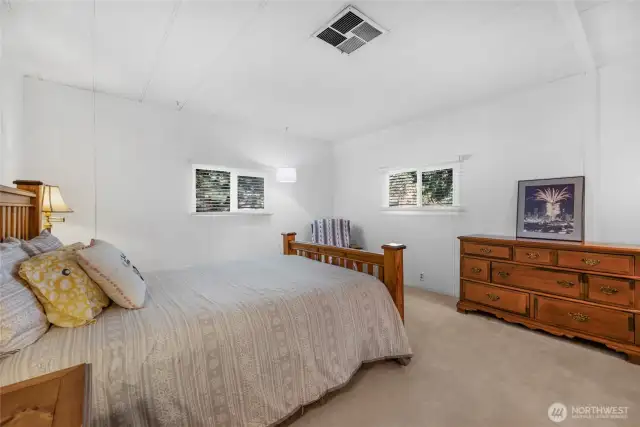 Very spacious primary bedroom suite with room for a King size bed and extra reading area. Wall to wall carpeting.
