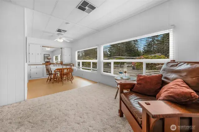 Floor plan in the home has a nice flow. The living room leads to the open dining room area,  A wall of windows that get western exposure.