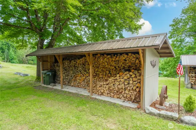 There are two covered storage areas, this large wood shed is one of them.
