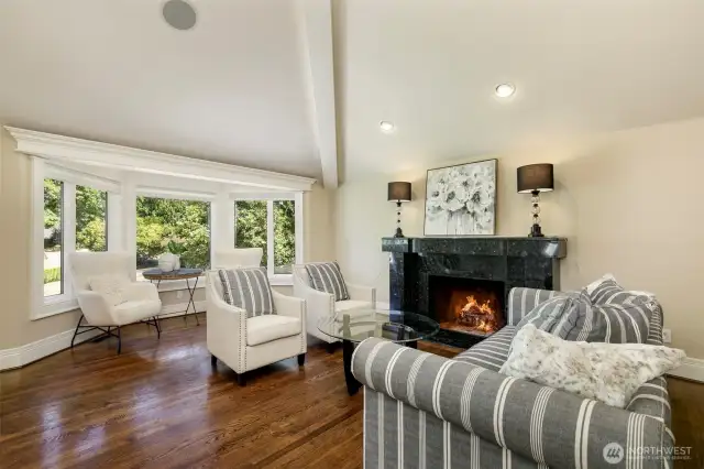 Living room with bay window and wood fire place