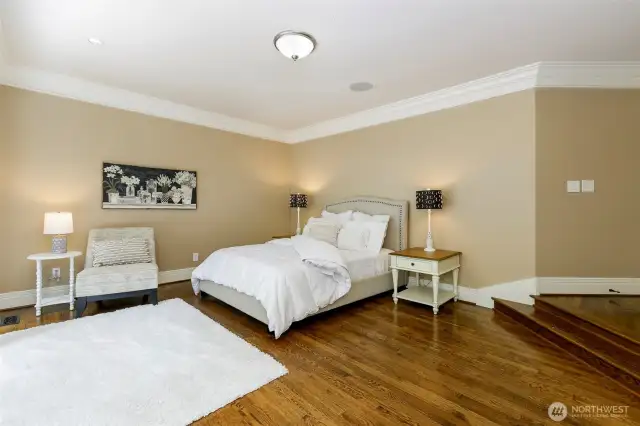 Large primary bedroom ready for King-size bed. Show with Queen.