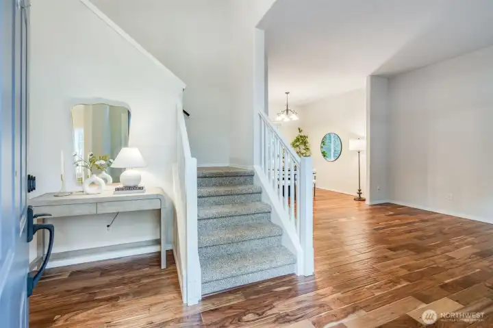 The elegant formal living room greets you upon entry, providing a sophisticated space perfect for receiving guests. This room flows seamlessly into the dining area and den.